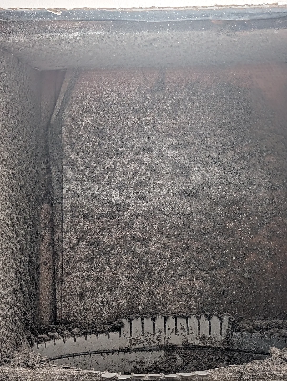 Inspection photo: severe dust and lint buildup inside a metal duct box